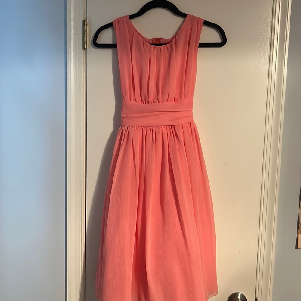 Cute peach pink girls dress with bow in the back